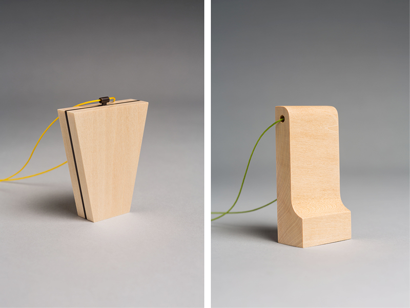Kevin Hughes, (left) Center Line, 2016, pendant, black patina on brass, basswood, 50 x 15 x 60 mm; (right) Untitled, 2016, pendant, black patina on brass, basswood, 25 x 15mm x 100 mm, photo: artist