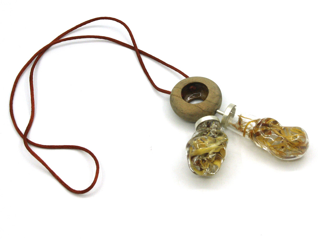 “As we face the reality of climate change,” writes Schoeman, “it is pertinent that a constant awareness of our actions and our relationship with our natural environment is cultivated. By creating jewelry objects that are meant to be placed on the body, I hope to emphasize the importance of the interdependent relationship between humans and our natural environments. These intimate pieces aim to promote a more sustainable understanding of the ecological balance in order to maintain a healthy relationship with our natural environment.” | Jané Schoeman, Co-existence, 2020, neckpiece, plant-based materials, glass, resin, wood, silver, photo: Joani Groenewald Jané Schoeman, Co-existence