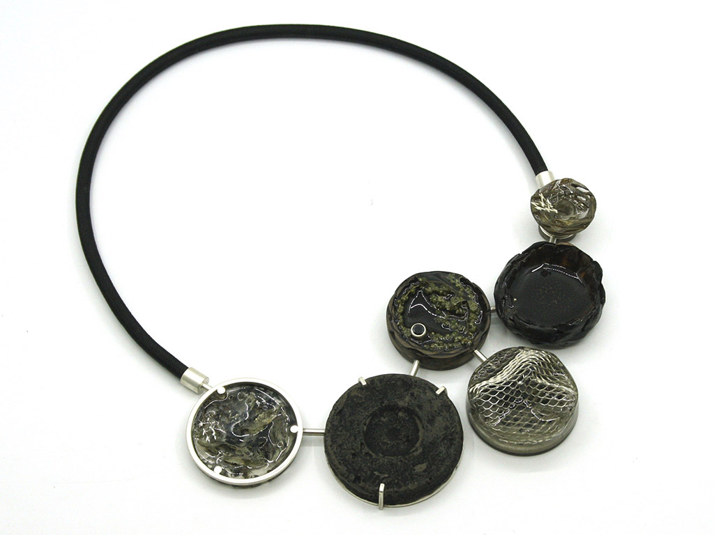 Stellenbosch University, in South Africa, named Jané Schoeman its outstanding student of the year because “Schoeman’s work combines the innovative and creative use of mixed media to create jewelry pieces that can convey meaning to the wearer/viewer. She successfully marries both intricate technical execution and visual conceptual design in her body of work. Jewelry is a multifaceted tool for communication and representation, and at Stellenbosch University we aim to produce a student that fully understands the medium, engages with it critically, and can manipulate it in innovative ways to create a dialogue that is both relevant and gripping.” | Jané Schoeman, Co-existence, 2020, neckpiece, plant-based materials, silver, metal mesh screen, concrete, activated charcoal, synthetic gemstone, photo: Joani Groenewald Jané Schoeman, Co-existence