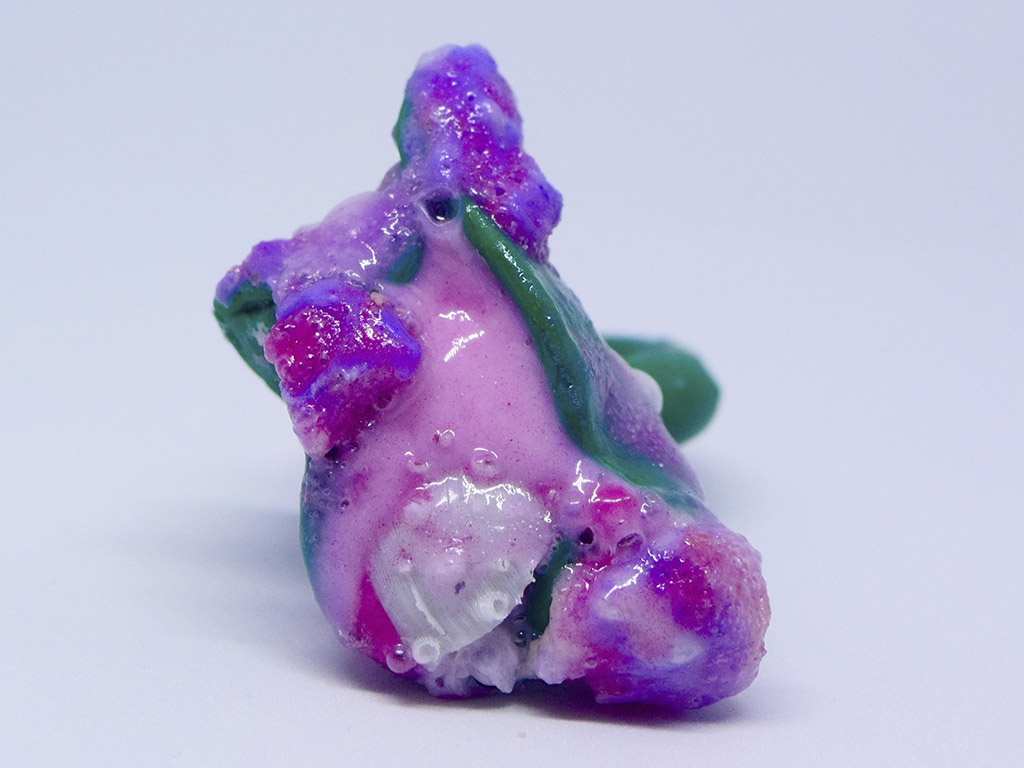 Associate Professor Rebecca Hannon states: “Her earrings and rings are painterly compositions, each vantage point a surprise to the viewer. New created materials—a hybrid of man-made and natural—are said to be the substance of the Anthropocene, and Sckye’s subject matter and materials choices do pose a question to the wearer. The artist’s adornment brings a laser focus to the unnoticed, the chosen, and challenges our interpretation of the jewel.” | Sckye Dickinson, Urchin Ring-Green, 2021, ring, rubber, silicone, clay, photo: artist Sckye Dickinson, Urchin Ring-Green
