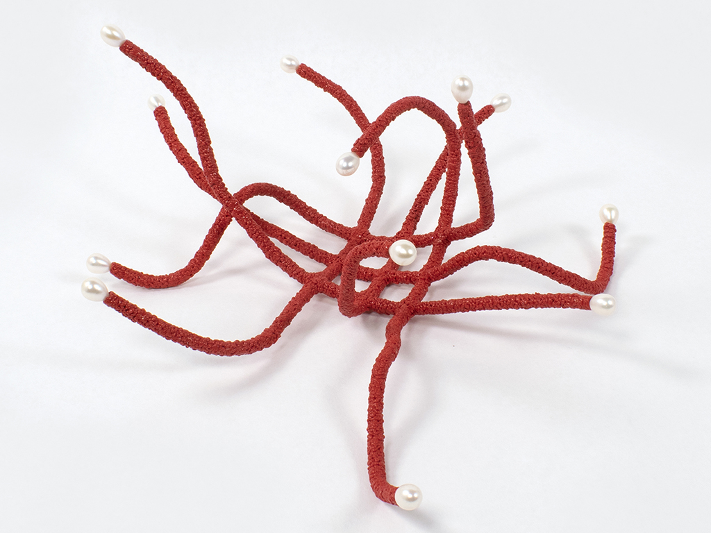 Assistant Professor Batchelder continues, “While focusing on the development of her practice over the past two years, she has also exhibited her work nationally, created and marketed a new line of production jewelry, and gained teaching experience as instructor of record. Claire is a natural creative leader and played a key role in organizing and presenting “denizen,” our annual MFA exhibition during NYCJW, and notably curated and installed a significant permanent exhibition of metal and jewelry from the Dorsky Museum of Art’s permanent collection on campus. Claire’s infinite energy, professionalism, and creative originality make her highly deserving of this recognition as a truly outstanding graduate and emerging artist.” | Claire Webb, Cartesian Creeper, 2021, object, polylactic acid, pearls, epoxy clay, silver, 350 x 350 x 200 mm, photo: artist Claire Webb, Cartesian Creeper