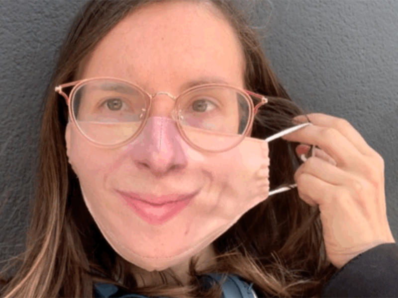 A still from a GIF showing a woman wearing a mask printed with her own features, courtesy of maskalike.com