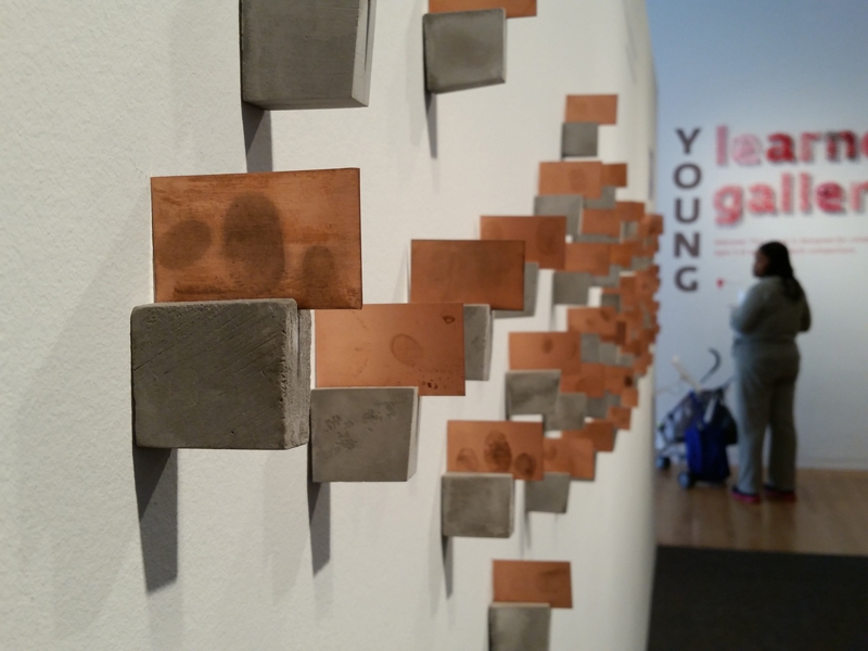 The Mother Load: Dallas, Center for Creative Connections, Dallas Museum of Art, detail of oxidized, fingerprinted copper plates on concrete, 2014-2015, photo courtesy of the Dallas Museum of Art The Mother Load: Dallas