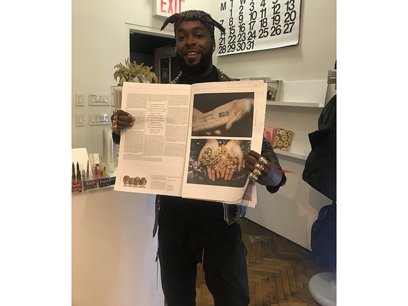 Artist Johnny Nelson holding the Current Obsession x NYCJW Paper featuring his work at his solo exhibition at Project No.8 within the Ace Hotel, photo: NYCJW Artist Johnny Nelson
