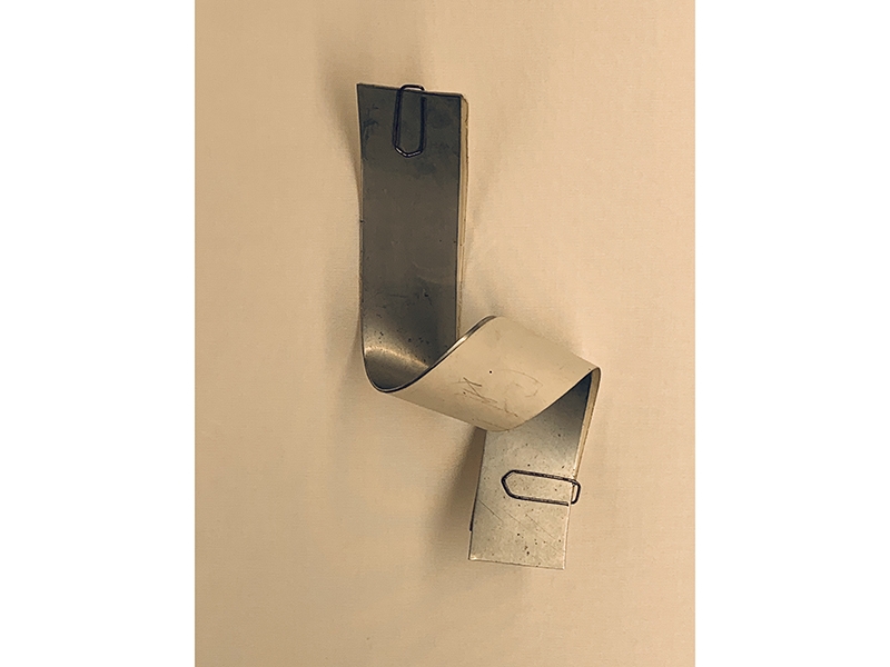 Detail inside the wall showcase. Francesco Pavan, mock-up for a “tessuta/tessotu” brooch, 1989, paper, aluminum, photo: Liesbeth den Besten Detail inside the wall showcase. Francesco Pavan, mock-up for a “tessuta/tessotu” brooch, 1989, paper, aluminum