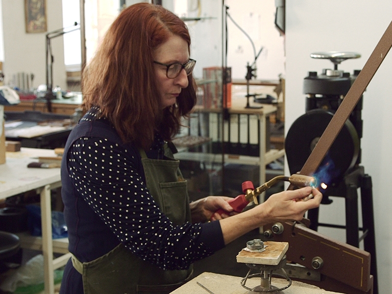 A still from Hunter from Elsewhere, showing Helen Britton at work in her studio