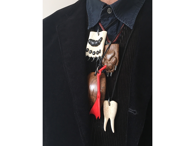 Mike Holmes wearing his collection of Jane Dodd pendants, 2014–2017, carved woods and bone, sterling silver, cord, photo: Nikki Couppee Mike Holmes