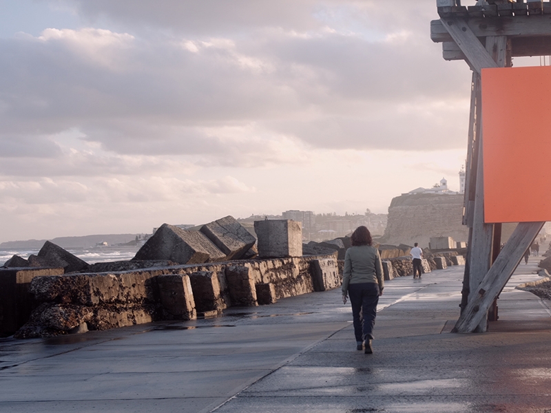 A still from Hunter from Elsewhere, showing Helen Britton walking on the pier in Newcastle, Australia, courtesy of ochobarcos filmproduction A still from Hunter from Elsewhere, showing Helen Britton walking on the pier in Newcastle, Australia