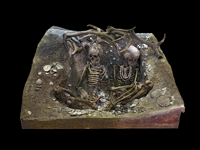 Tomb of Téviec, two skeletons of women dated between 6,740 and 5,680 years ago (Mesolithic) protected by antlers; grave goods include flint, wild boar bone, deer teeth, pierced pebbles, marine shells drilled and assembled into necklaces, bracelets, and ankle rings. Some of the bone objects have engraved lines, photo: Didier Descouens, Muséum de Toulouse/Wikicommons. https://upload.wikimedia.org/wikipedia/commons/e/e4/S%C3%A9pulture_de_Teviec_Global.jpg Tomb of Téviec, two skeletons of women dated between 6,740 and 5,680 years ago
