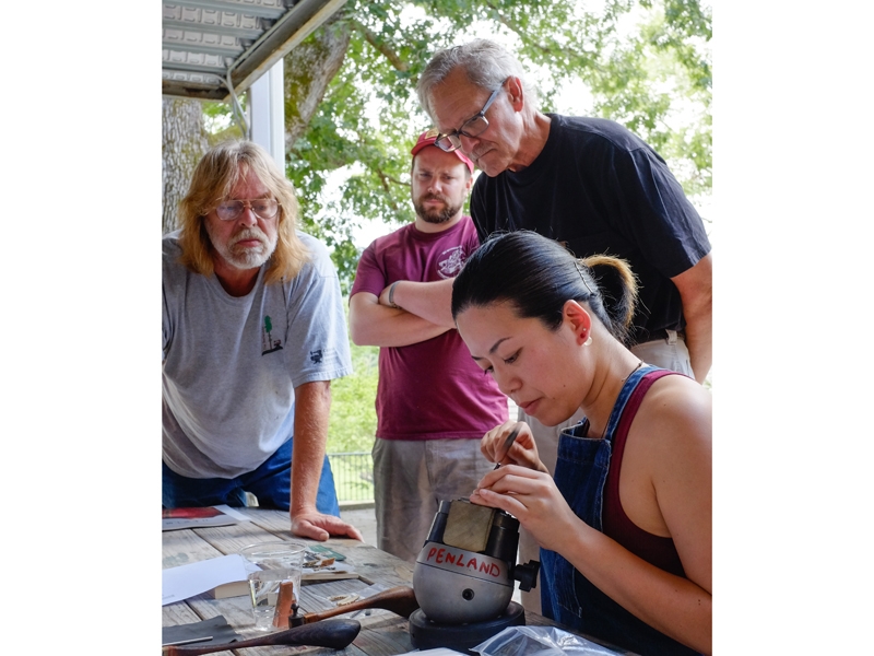 Students watch a demonstration on the metals studio porch during a summer workshop, photo: Robin Dreyer Students watch a demonstration on the metals studio porch