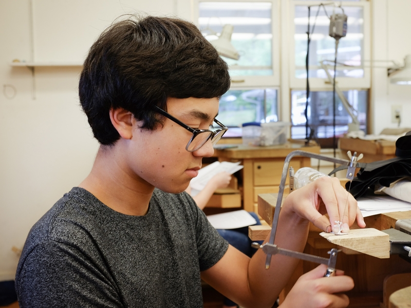 A student at work at a bench in one of Penland’s two metals studios, photo: Robin Dreyer A student at work