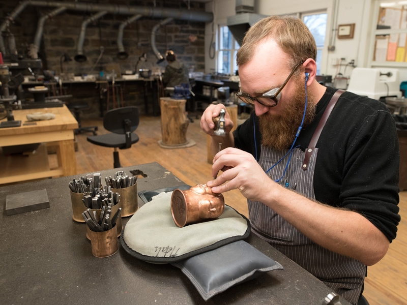 Metals studio assistant Adam Whitney adds detail to a cup during Penland’s winter residency, photo: Robin Dreyer Metals studio assistant Adam Whitney adds detail to a cup