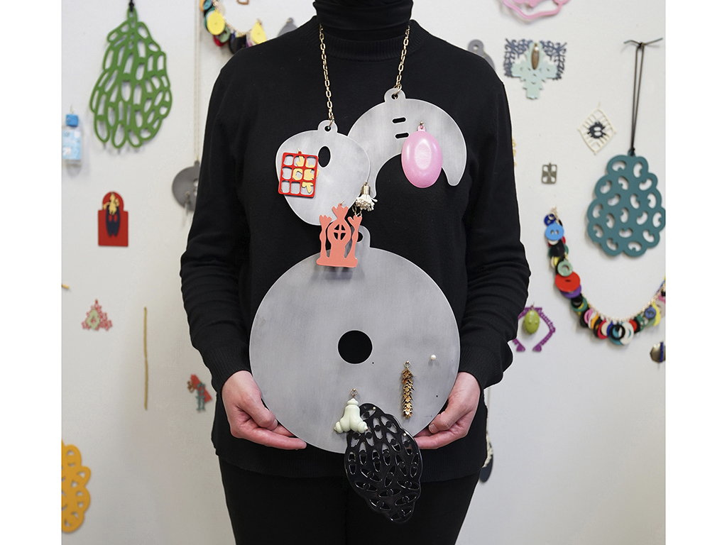 “The confusion regarding my identity is present in the work itself,” writes Almajidi. “Drawing from the multiple cultures I inhabit, there is an ambiguity in the forms that makes it so one cannot quite place the forms in the cultures being referenced. Culturally specific signifiers are melded together to create hybrid forms that confront the viewer’s understanding of the object’s identity. This is further complicated by the fact that the viewer is often looking for answers amongst a group of works that become more ambiguous as the objects are manipulated. Working on multiple pieces makes it so that I can think through several ideas and concepts at a time. Each piece within a series also presents an opportunity to experiment with form and technique.” | Zahra Almajidi, Where Are YOU From?: Collectors (Select Objects), 2021, charm necklace, steel, brass, 3D-printed polylactic acid plastic, pearls, plastic flower stamens, powder coating, dimensions variable, photo: Bonnie Xue Zahra Almajidi, Where Are YOU From?: Collectors (Select Objects)