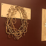 "Necklaces by (left) Nancy Slagle (&quot;Brambles&quot;) and (right) Nancy Slagle (&quot;Binary 001&quot;) mounted to the wall in the exhibition &quot;Not"