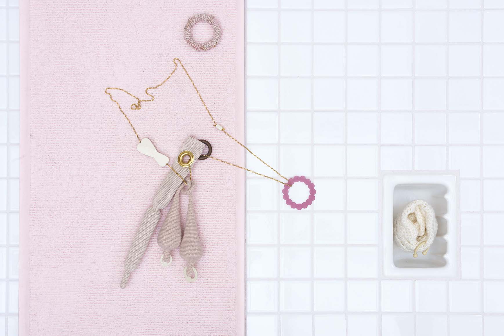 Tatum Gentry, Expert from Expert of a Bathroom, 2019, Necklace and Sock, yarn, brass, aluminum, powder coating, rubber o-ring, plexiglass, 18k plated ball chain, 22 x 5 x 3 inches, Photo : Carlson Productions 