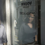 Teresa Milheiro gazes into her window project, Spy On, photo courtesy of Teresa Milheiro