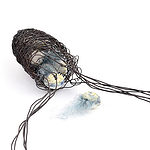 “While walking locally during lockdown,” says Brown, “I found some ‘sputniks’ nestling in a woven cocoon in the woods.” | Alison Shelton Brown, Trapped Sputniks, 2021, woven wire with hand-made porcelain hollow balls and silk fibers, photo: Robin Shelton