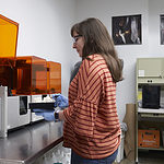 Metals/Jewelry/CAD-CAM graduate student working at 3-D printer, a notable