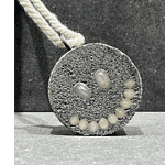 The smiling faces can be a reminder to be happy because, indeed, life is short. Ambroise Degeneve made a smiling pendant for a show called Memento Mori (“Remember You Must Die”). | Ambroise Degeneve, Memento Mori, 2021, pendant, concrete, pearls, silver, cotton, photo courtesy of the artist