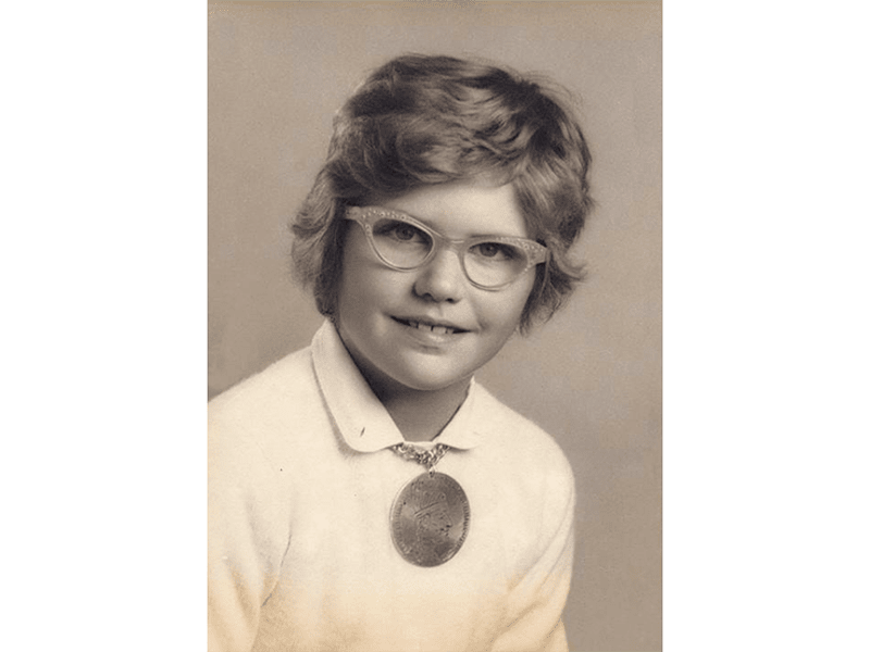 Sharon Church wearing the aluminum pendant she made from a kit as a child
