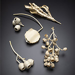 Jess Dare, inspired by the shapes of the plants and shells she and her son collect, makes necklaces and brooches of a cream-colored, powder-coated brass. | Work by Jess Dare, at Atta Gallery (within Frame), photo courtesy of Atta Gallery