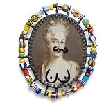 Geraldine Fenn’s “Colonial Comeuppance I” (shown) turns the tables on the European colonists of Africa. Its portrait of a grand lady has been marred with graffiti that gives her a mustache and breasts. The piece turns colonists into objects being collected, to be looked at and exoticized, according to the artist, who is based in Johannesburg. Nanna Melland replicated an American toy ring from 1946 to explore themes of war and deterrence. “Ring of Ignorance” is a rendering of a miniature atomic bomb atop a gray tin ring. Melland, who is from Norway, wants us to think about the way that post-WWII American propaganda, which employed the toy ring as a tool, promoted nuclear weaponry as a means to peace, but many wars, including the one in Ukraine, have been launched since then. | Geraldine Fenn, Colonial Comeuppance I, photo courtesy of the Schmuck exhibition