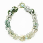 There was charm and surprise in the use of unconventional materials, from Bic lighters to Scotch tape. Zixin Wei’s “Scotch Tape and Jade” necklace (shown) juxtaposes high and low materials by interspersing rings of jade with elements from the tape. While searching one day for Scotch tape, Wei found it mixed with a jade ring, and “suddenly I felt that there must be some chemical reaction between these two things,” the artist wrote. “One covers a hundred million years of experience, and the other clings to the dust and hair around the present.” Andrea Auer’s necklace “Tixo” also uses tape, but only commercially available rolls of transparent self-adhesive tape, the rings attached to each other to form a chain. And Bas Bouman, who is from The Netherlands, paid tribute to his mother by crafting a necklace out of the bones she used to make Saturday soup for the family. The uniformly white bones in “Bou” are carved into a chain that recognizes the love his mother put into each meal and the animals that supplied the bones. | Zixin Wei, Scotch Tape and Jade, necklace, photo courtesy of the Schmuck exhibition