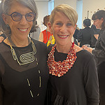 (Left to right) Susan Ach greets Bonnie Levine, the chair of AJF’s board. Levine has on a necklace by Yumi Kato made of repurposed silk from discarded Japanese kimonos. Photo: Jennifer Altmann