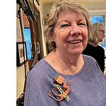Susan Kempin wears a brooch by Bruce Metcalf