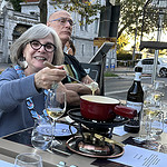 Patti Bleicher enjoying fondue, one of the yummy and oh-so-Swiss options for dinner. Bob Bleicher sits beside her.
