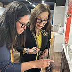 Artist Catherine Sheedy and AJF traveler Edie Nadler looking at jewelry at Galerie Noel Guyomarc’h.