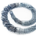 Jiashi Ying, <em>Roll Necklace,</em> 3D-printed TPU (thermoplastic polyurethane) on organza, sterling silver, stainless steel, photo: Jiashi Ying @jiashiyingjosie, Mengtong Yu @yumengtongjewel | Immerse yourself in the gentle whispers of the sea with an exquisite necklace inspired by the rhythmic waves. Each delicate undulation of the pendant resonates like a harmonious melody, enveloping the soul in a profound serenity. Crafted from lightweight, supple materials, it glides against the skin like silk, evoking the caress of a sea breeze. Every intricate detail on the necklace mirrors the gentle ripples of the ocean, offering a comforting and blissful touch, as if wandering in the embrace of the sea. 