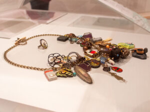 Robert W. Ebendorf and various artists, ECU Charm Necklace, 2017, silver, copper, brass, enamel, mixed media, found objects, 48 x 5 x 3 inches (1,219 x 127 x 76 mm), Collection of The Mint Museum, Gift of Porter • Price Collection, 2022.49.7, photo courtesy The Mint Museum