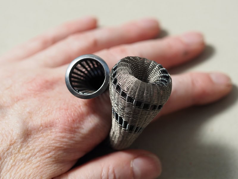 Jane Bowden, Woven, 2024, ring in titanium, sterling silver, top 2 x 1 ⅛ inches (50 x 30 mm), 2 ⅜ inches (60 mm) tall, photo: artist