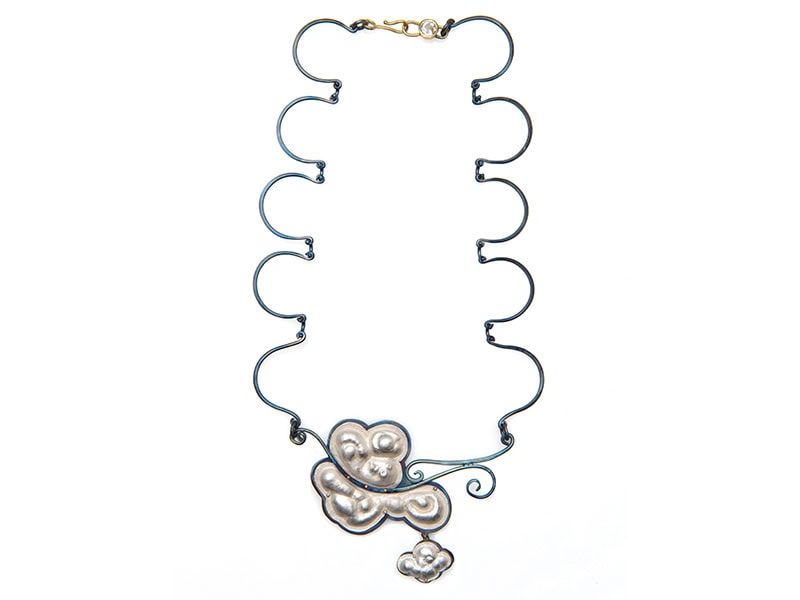 Bethamy Linton, Seventh, 2025, in anodized titanium, fine silver, 18-karat gold, blue topaz, pendant 21 ½ inches (550 mm), 3 ¾ x 2 ¾ inches (95 x 70 mm), photo: Eva Fernandez