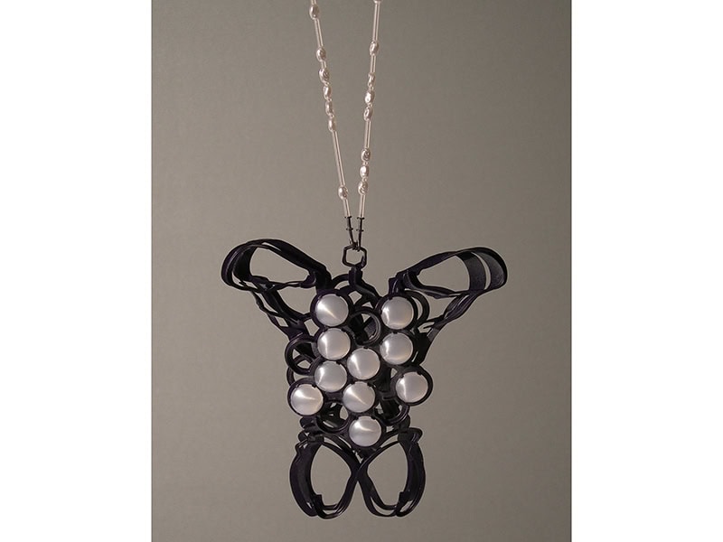 Norman Weber, Show Piece #6, 2009, pendant in blackened silver, plastic stones, plastic beads, paint, steel cable, silicone, 6 ⅝ x 6 x 1 ¼ inches (167 x 153 x 33 mm), photo: artist