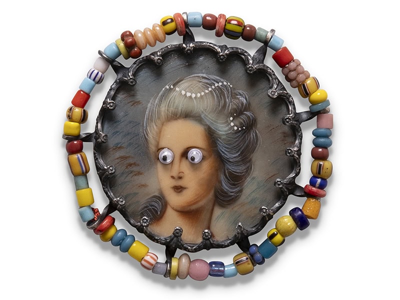 Geraldine Fenn, Colonial Comeuppance XII: Obscured, 2024, necklace in oxidized silver, found object (vintage painted miniature), glass seed beads, resin, photo courtesy of the artist