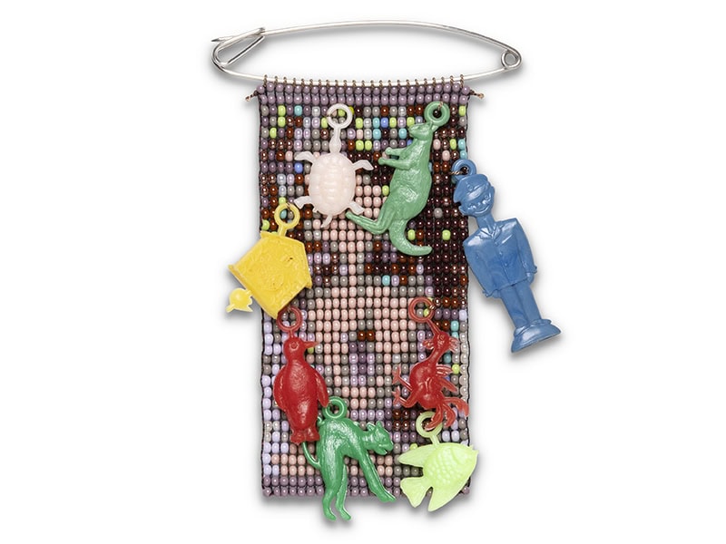Geraldine Fenn, Untitled (Plastic Charms), 2025, brooch in glass seed beads, thread, silver, found objects (plastic charms), photo courtesy of the artist