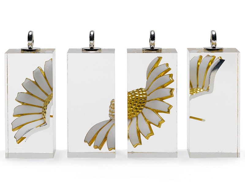Kim Buck, Daisy, Freely after Niels Heidenreich, 2007, pendants in Georg Jensen marguerite brooch, epoxy resin, silver, 2 inches (50 mm), photo: Anders Sune Berg