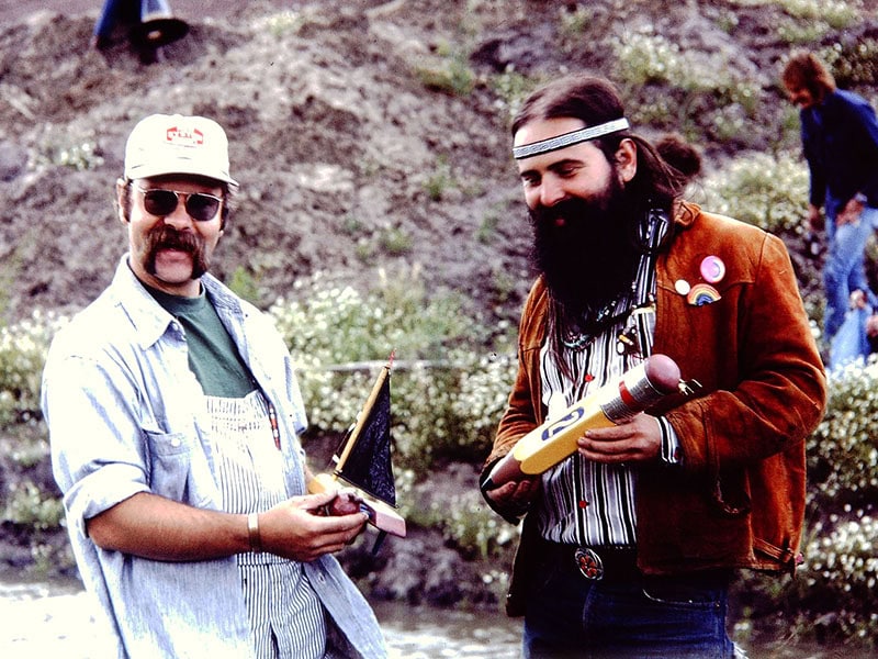 (Left) Les LePere and (right) Ken Cory, the Pencil Brothers, with their handmade boat at a regatta sometime in the 1970s, image courtesy of the estate of LWL
