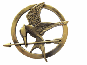 Dana Schneider designed the Mockingjay pin worn by the character Katniss Everdeen in some of the “Hunger Games” movies. This is a replica mass-produced for sale to the public, photo drawn from amazon.com/Hunger-Games-Movie-Mockingjay-Prop/dp/B0074BVDWC