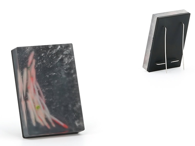 Julia Obermaier, From Above, 2025, brooch in rock crystal, onyx, stainless steel, pigment, 2 ⅜ x 1 ⅝ x ⅜ inches (60 x 40 x 10 mm), photo courtesy of the artist