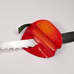 “Color is an essential tool in my creative process; it is emotion, narrative, and play. My work is a constant exercise in enchanted observation, where the intimate becomes extraordinary, and where each piece functions as an invitation to look at reality through different eyes.” ||| Nasla Santillán Lara, Manzana Necia (Foolish Apple), brooch in hand-painted silver, brass, gesso, Prismacolor, nylon cord, 8 x 15 x 2 cm, photo courtesy of the artist