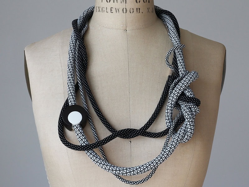 Jacqueline Lillie, Three Strand Diamond Pattern, 2019, neckpiece in black and white glass beads, individually knotted with black and white Corian clasp, sterling silver clasp and steel clasp, 54 inches (137.2 cm), photo courtesy of Sienna Patti
