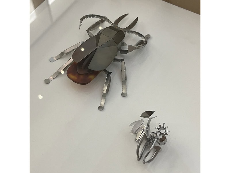 Minseok Kim, (left) Cervicornis, 2024, brooch in stainless steel, brass, cellulose acetate; and (right) Mantis, 2024, ring in stainless steel, nickel silver, at Pinakotek der Moderne, Munich, Germany, photo: Kellie Riggs