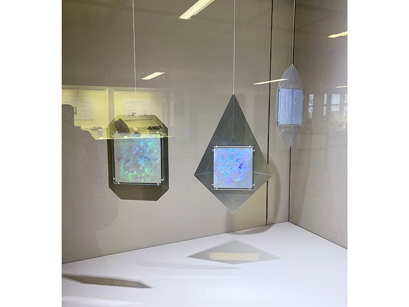 Moniek Schrijer, Gemstone Cut Pendants, glass plate reflection holography, aluminum, silver soft flex wire, 2023, at Mineralogy Museum Munich, Munich, Germany, photo: Kellie Riggs