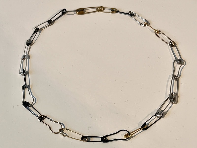 Giles Last, A Cycle of Design and Use, 2025, necklace in recycled silver and gold, found safety pins, at Vitsœ, Munich, Germany, photo: Kellie Riggs