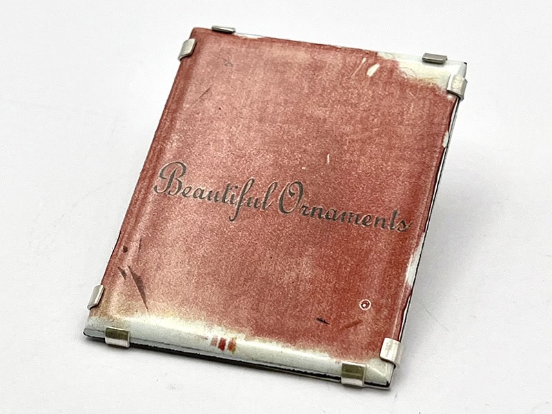 Cristina Lamas Beautiful Ornaments (Astrological Excuses series), 2025, brooch in photo enamel on copper, silver, stainless steel, 2 x 1 ⅝ x ⅛ inches (50 x 40 x 3 mm), photo: Catarina Silva