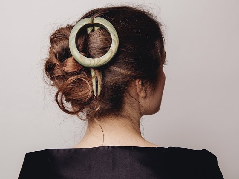 Oles Tsura, Human Hook III—Hairpin/Brooch, 2021, in wood, green pigment, photo: Patrick Gunning, stylist: Yael Reisner
