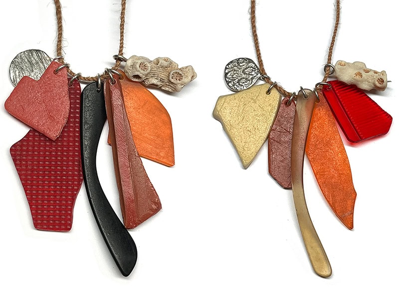 Melinda Young, Future Relic #1 and #2 (Pukatja, APY Lands/Shady & Sunny Beach, Yirrkala, NT/Dharawal Country, NSW), 2015/2017/2024/2025, necklaces in plastic marine debris, translucent and black sunglasses arm, orange car blinker light, red car brake light, coral, sterling silver coral imprint charm, driftwood imprint charm, bush string, 15 ¾ and 17 ¾ inches (400 and 450 mm) long, photo: Michael Couper